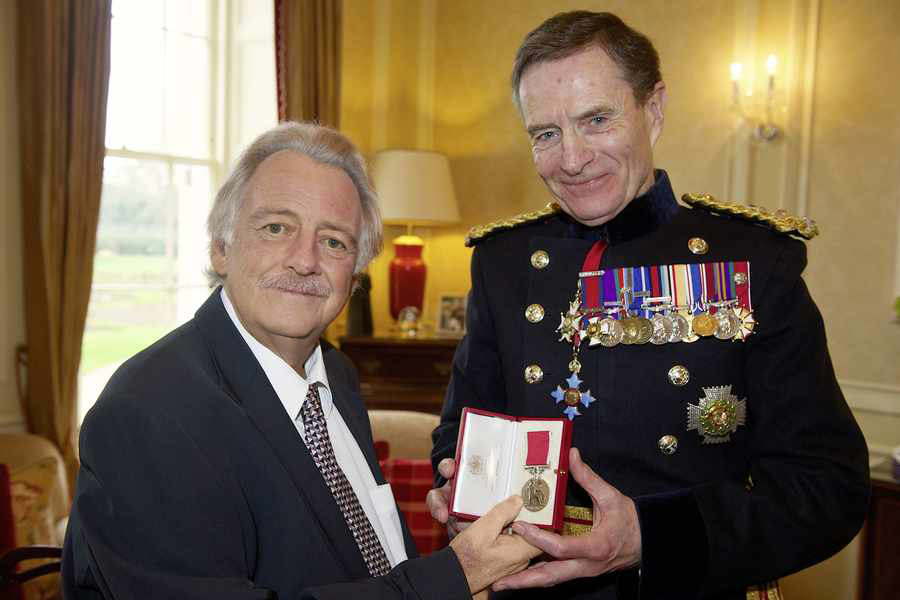 Colin_Taylor_receiving_British_Empire_Medal_from_the_Lieutenant-Governor_General_Sir_John_McColl_in_2015_just_before_he_died.jpg