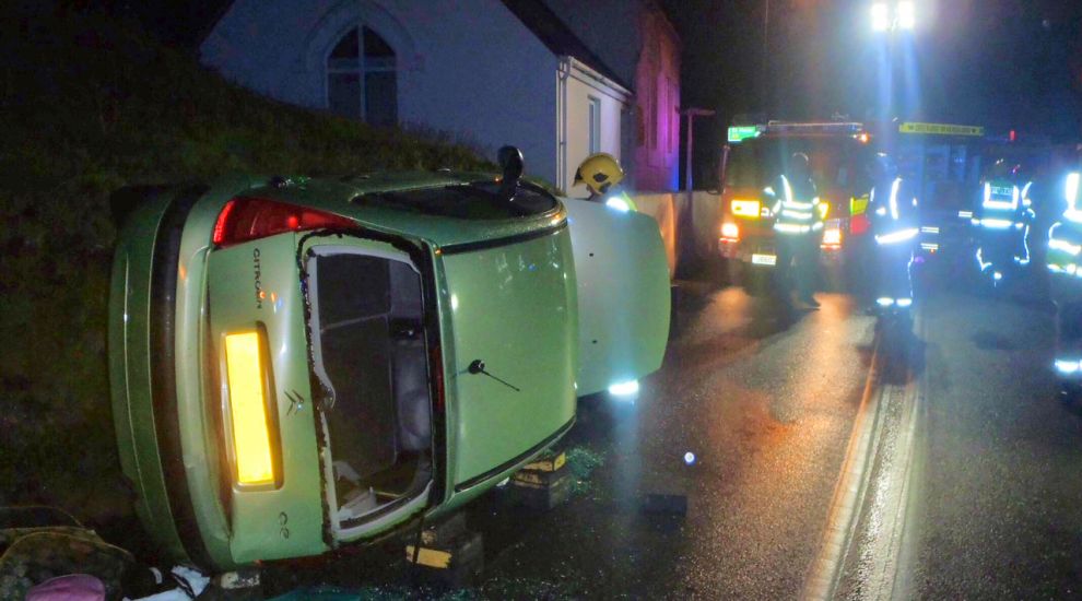 Firefighters cut casualty from upturned car