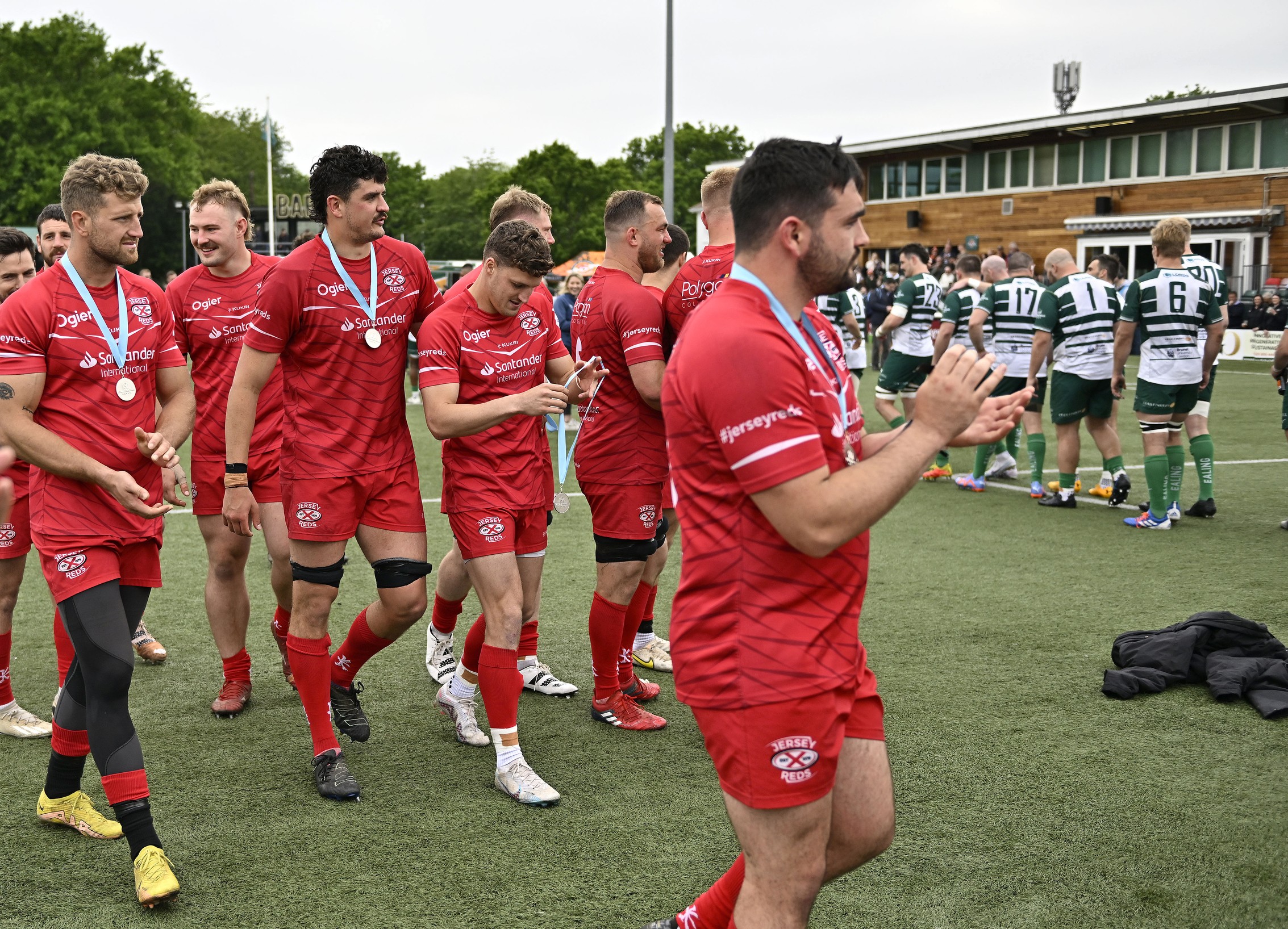 The Jersey players with their silver medals applaud as Ealing go up to receive the trophy during the Ealing Trailfinders V Jersey Reds RFU Championship Cup final rugby match on Saturday 13 May 2023. (Garry Bowden)