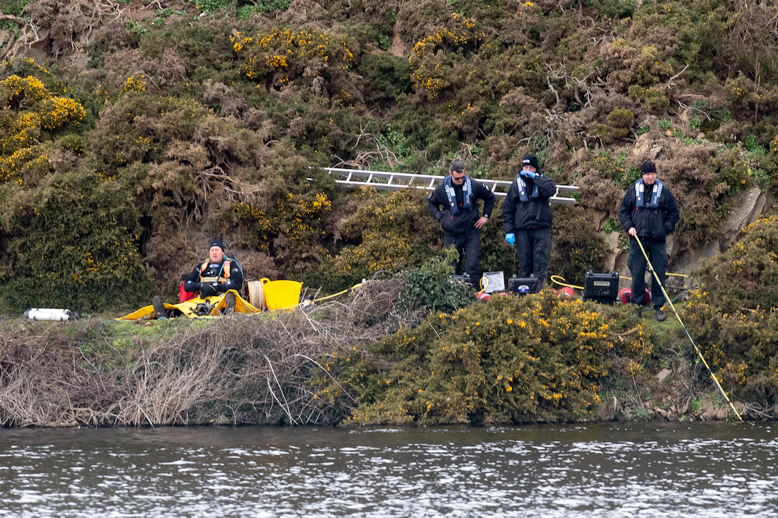 Standalone. Police divers from the UK search underwater whilst a boat covered the surface at Val de La Mare reservoir in the search for missing person Thomas Frost Picture: JON GUEGAN.