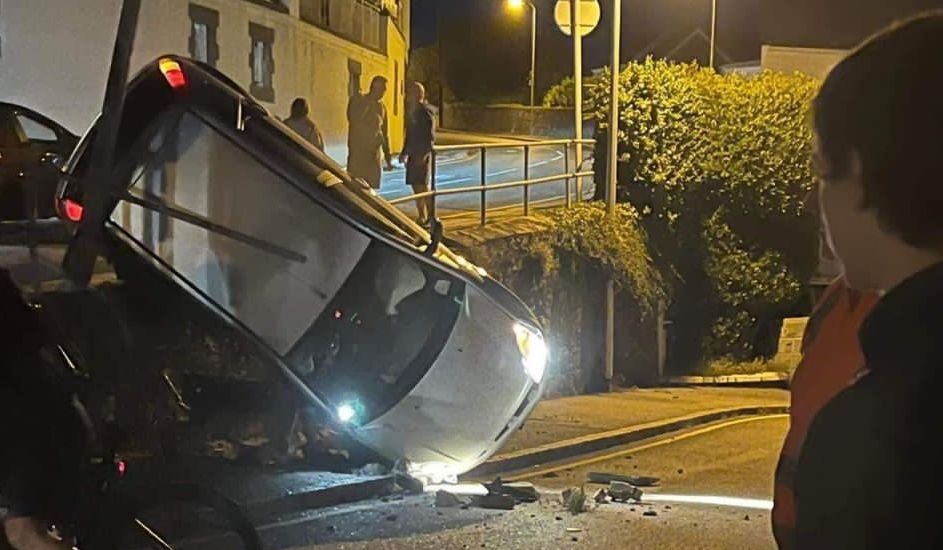 Car smashes through railings and nosedives in dramatic crash