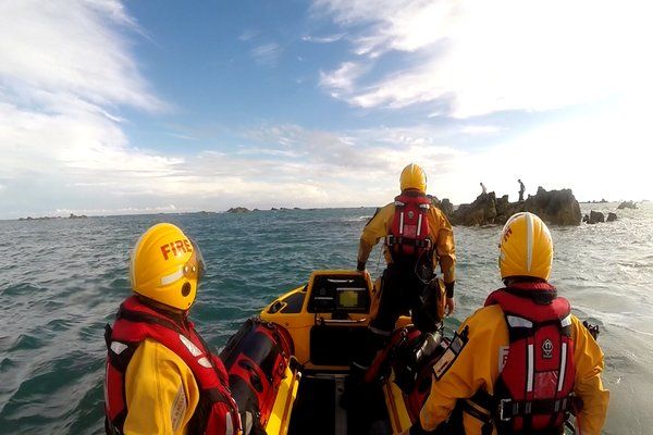 Two men rescued from rocks off St Clement