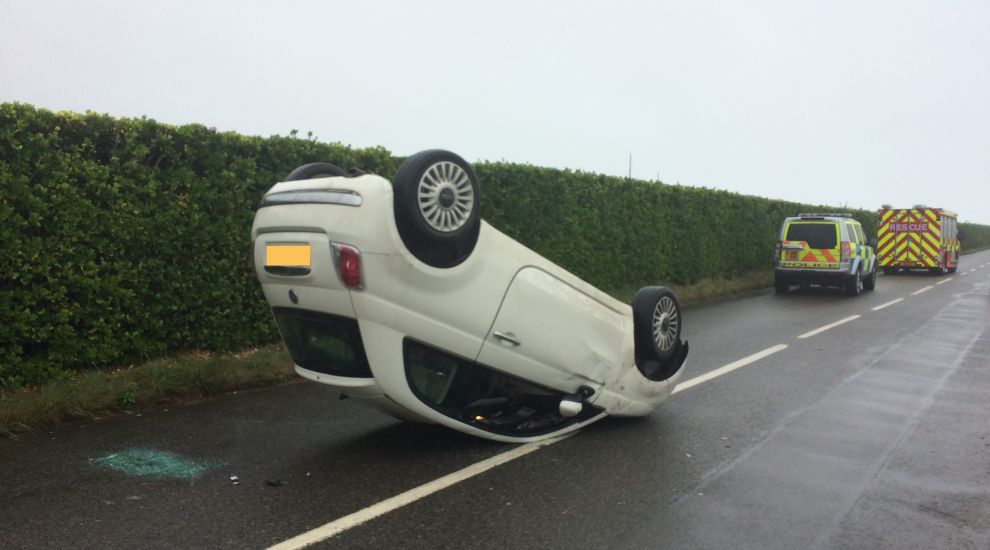 Woman walks away from overturned car