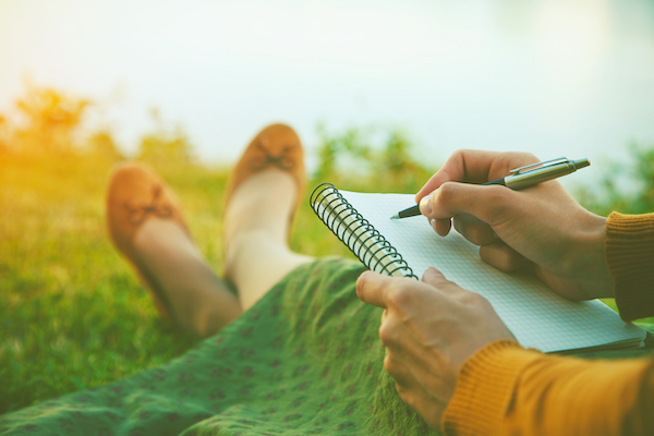 woman writing outside