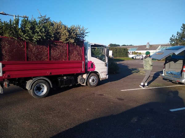 Truck_of_xmas_trees_Hospice_2021.jpg