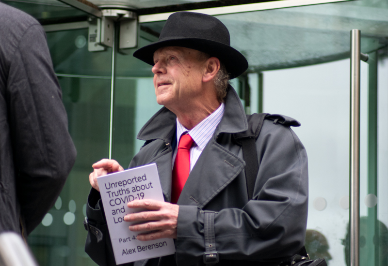 Deputy Lester Queripel holding anti vaccine book