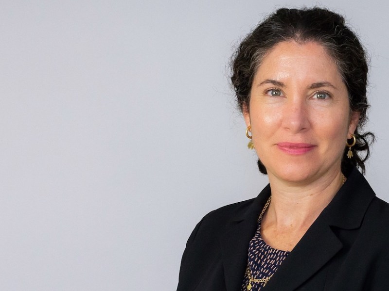 A woman with shoulder-length dark hair in a business suit.