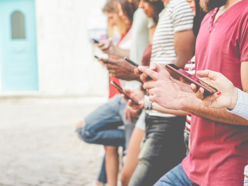 Young people on mobile phones.