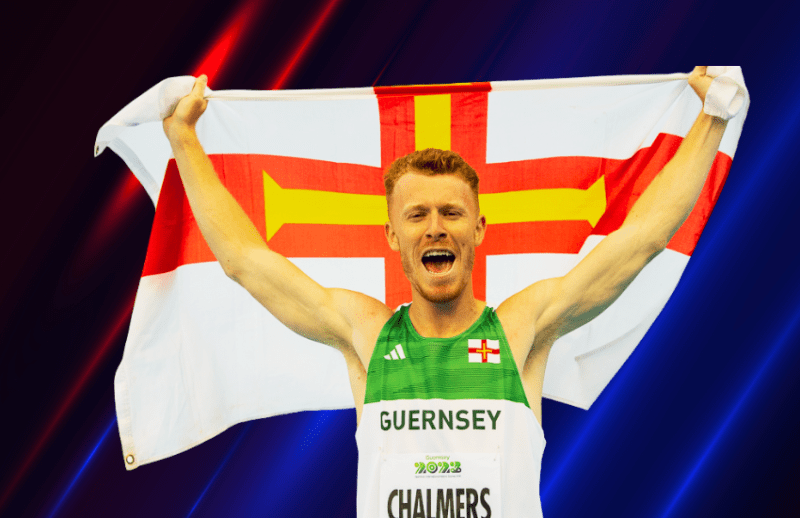 An athlete holds up a Guernsey flag.
