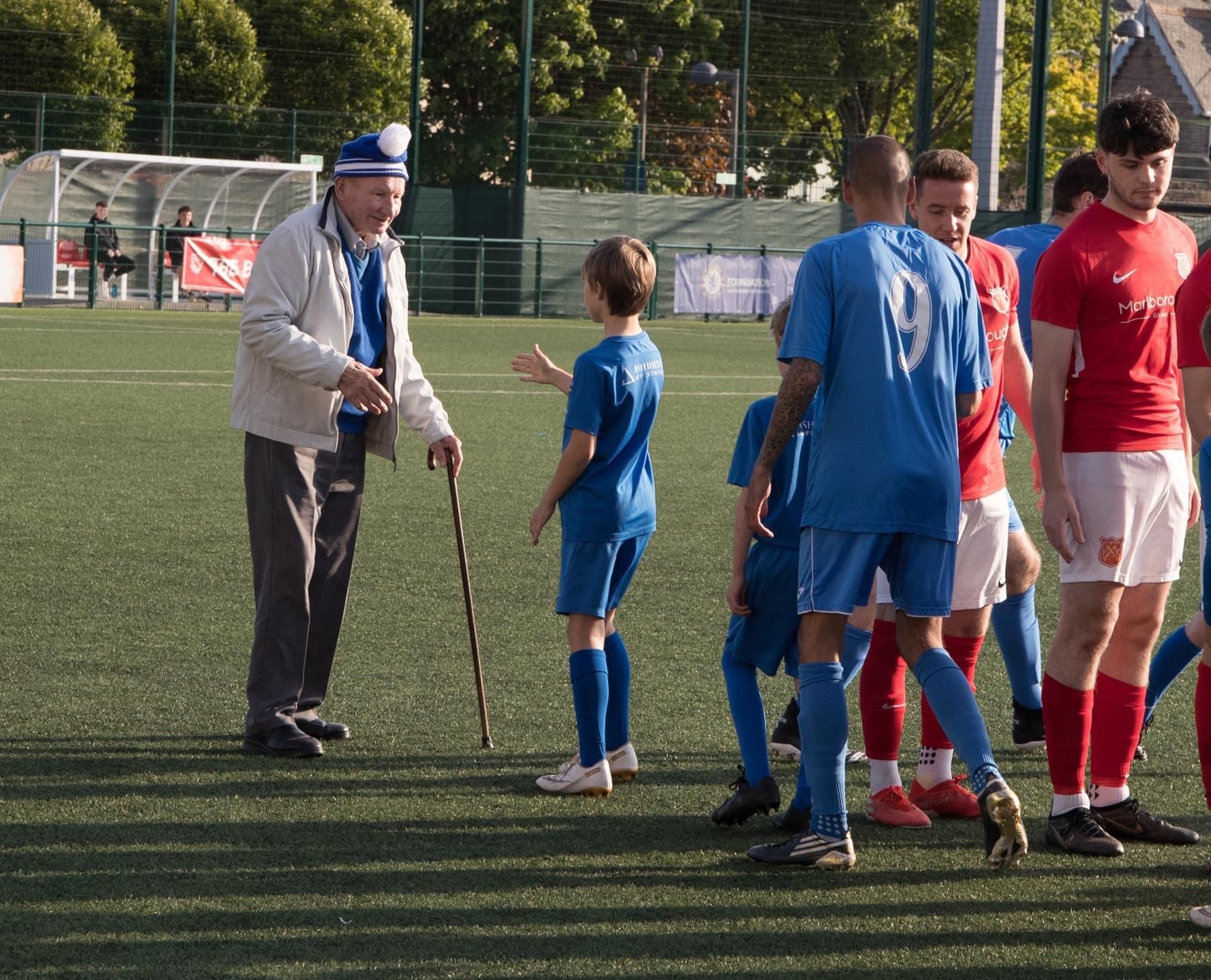 The_Generations_of_Grouville_FC._This_picture_is_enlarged_and_mounted_on_our_clubroom_wall_in_tribute_to_George_says_everything_about_the_love_and_respect_everyone_associated_with_Grouville_FC_has_for_him._1.jpg