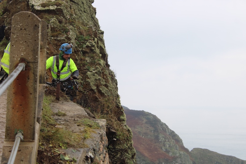 Pictured: Rope access specialists were tasked with carrying out aspects of the repair work. Jose Gouvaea looks out over the drop.
