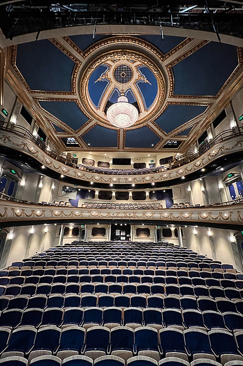 interior of refurbished opera house with dome and chandelier