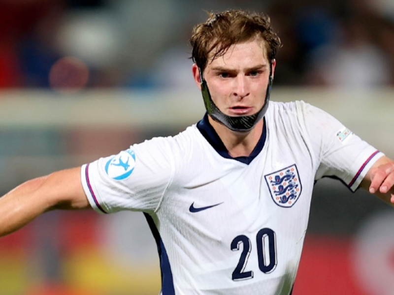 A young footballer in an England football top.