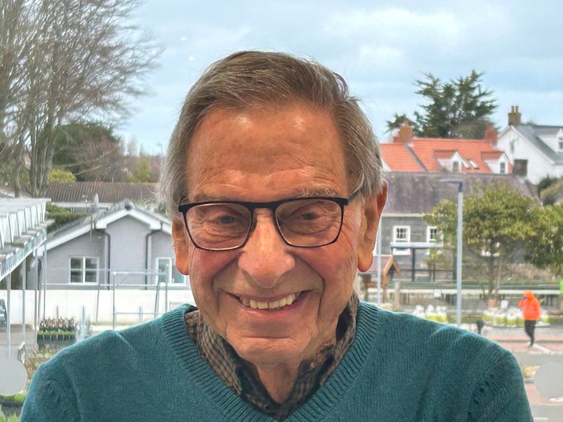 A smiling man in glasses.