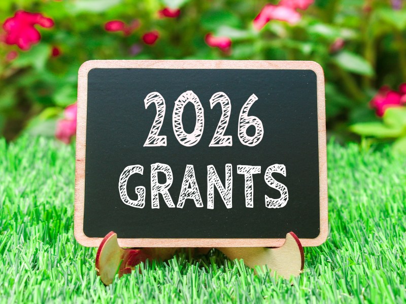 A blackboard on a neat lawn. It reads: 2026 grants.