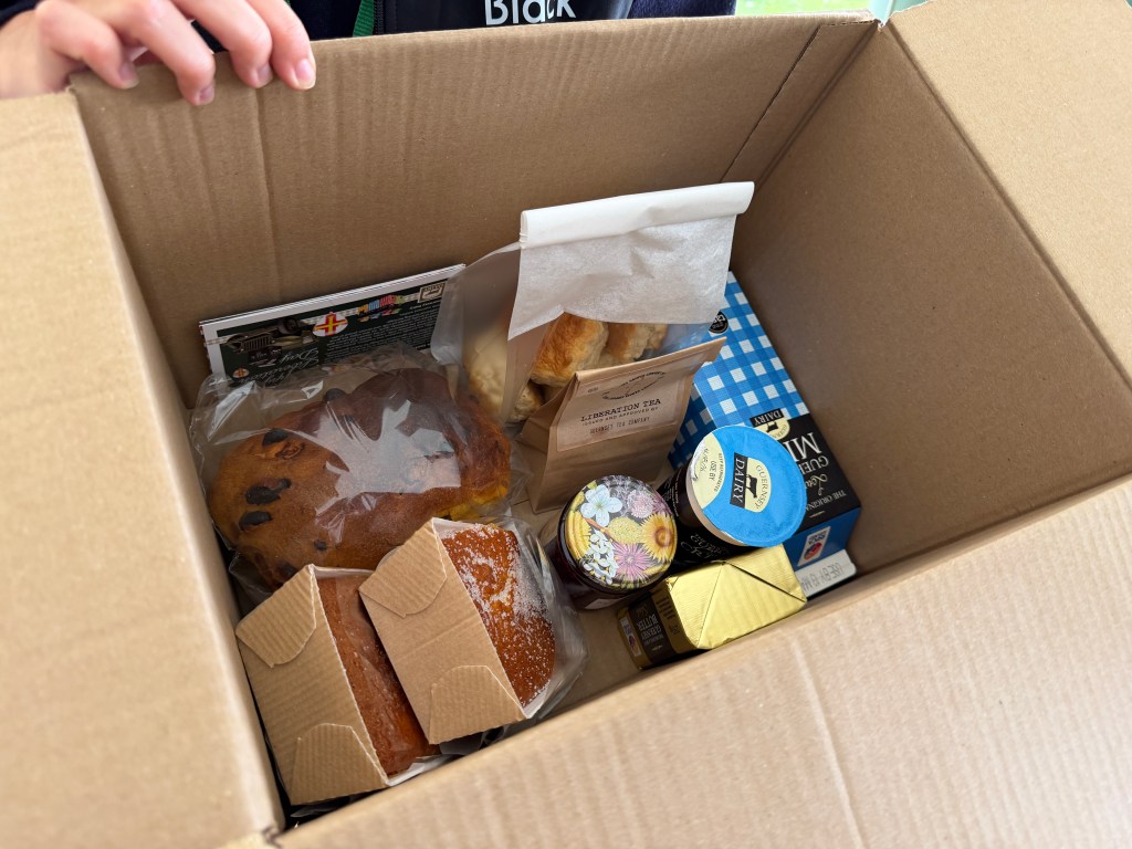 A hamper with milk, butter, cakes, Guernsey Gache and jam.