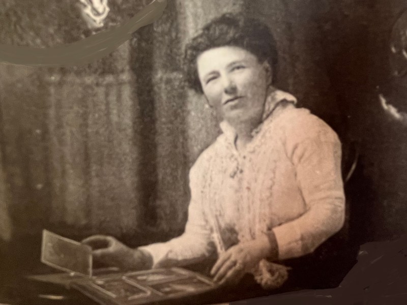 A sepia photo of a middle aged woman.