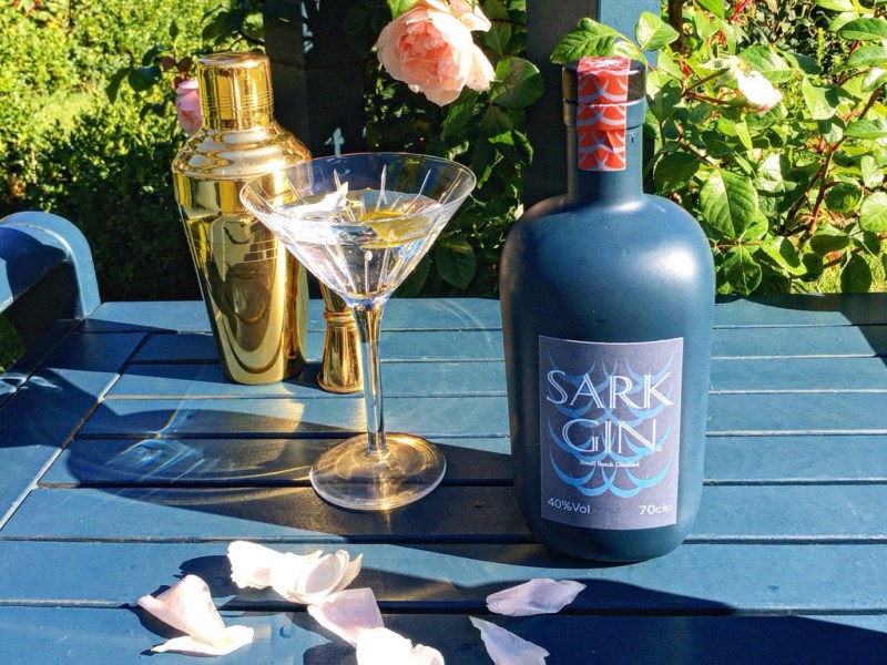 A bottle of Sark Gin on a table.
