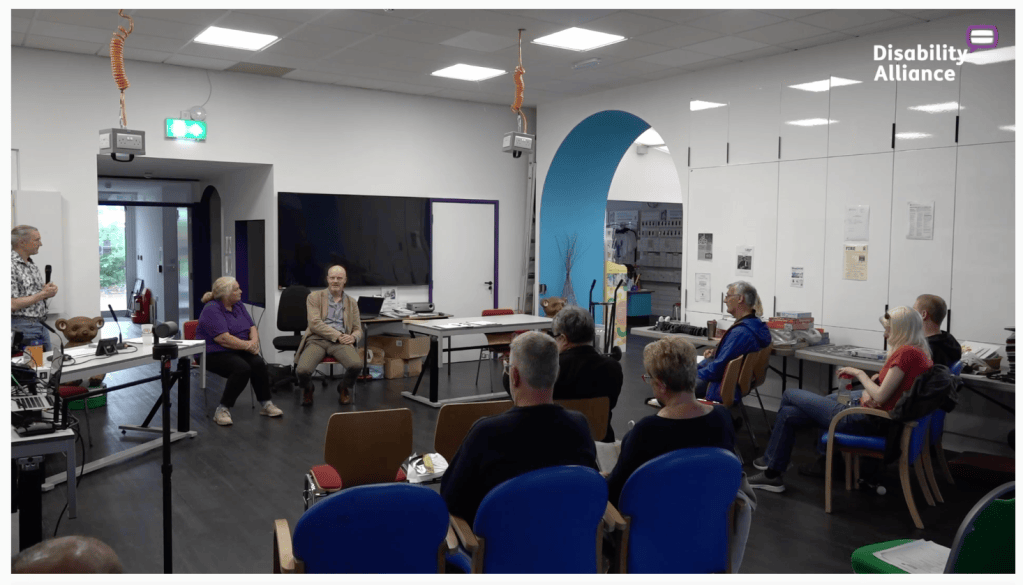 several people talking in a conference hall setup