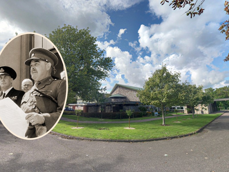 A modern crematorium sits in leafy grounds. Inset of a military commander in uniform reading a speech from a scroll of paper.