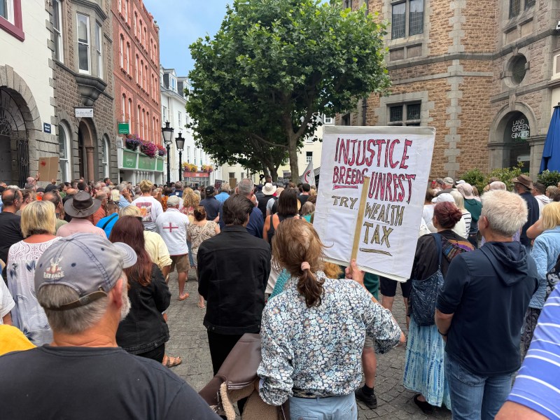 About 200 people at a small demo, holding onto GST placards.