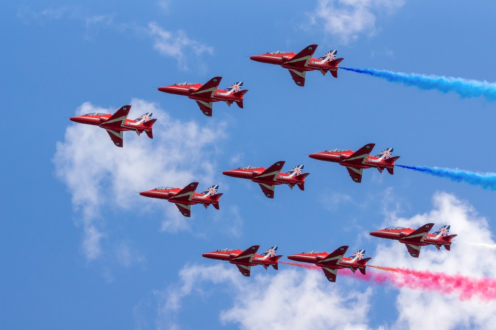 Dawlish, United Kingdom - August 23, 2014: The Royal Airforce Red Arrows aerobatics display team perform in diamond formation at the Dawlish Airshow in Devon, England