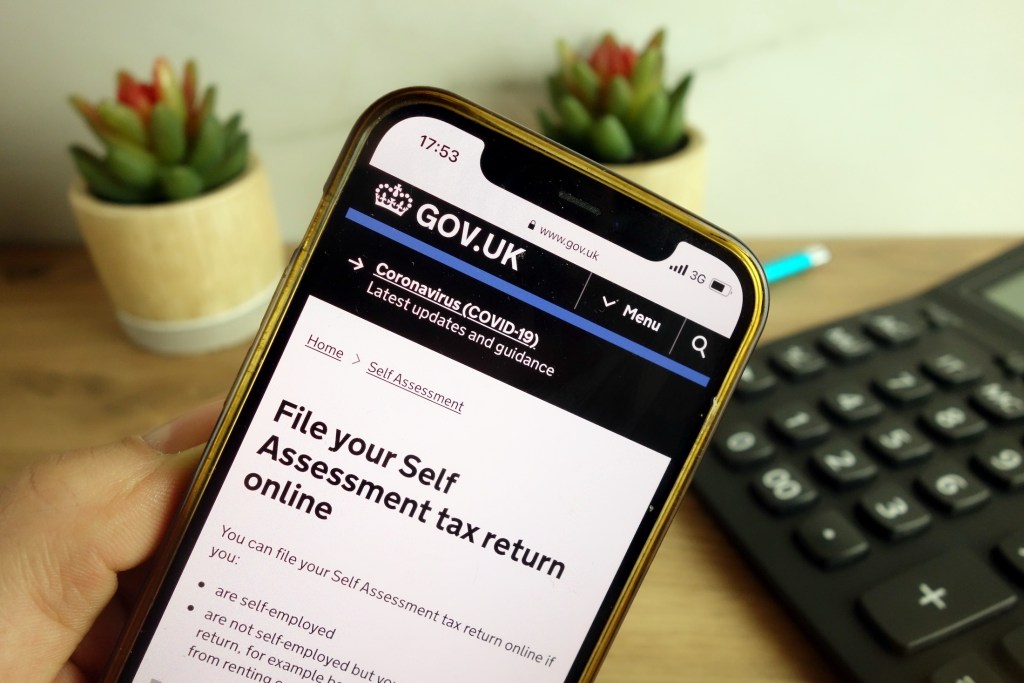 www.gov.uk website about filling self assessment tax return online displayed on mobile phone