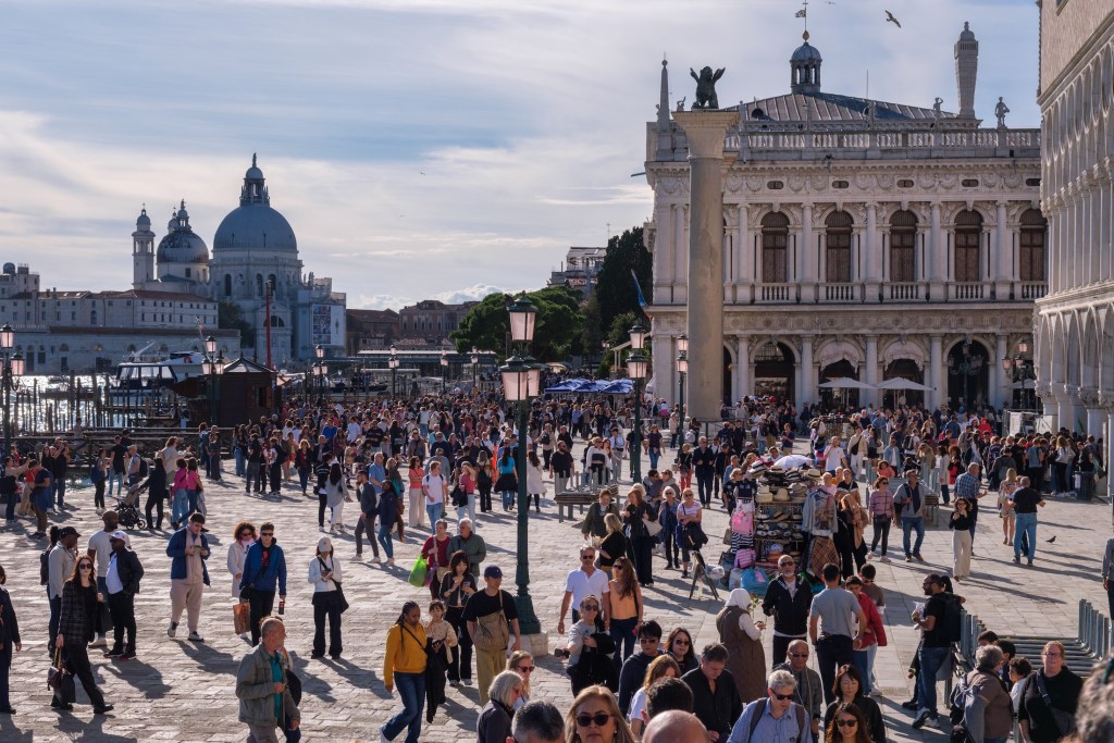 Venice, Italy - 12 October 2024: Crowded scene near St Mark's Square illustrating overtourism in Venice