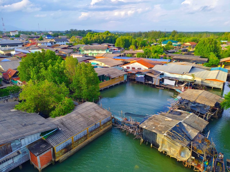 Drone shot of flooded village in Nepal. An informal settlement with huts up the roof with water.
