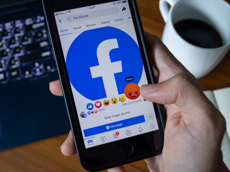 Facebook user touch on Angry button in Facebook application on iPhone 7.